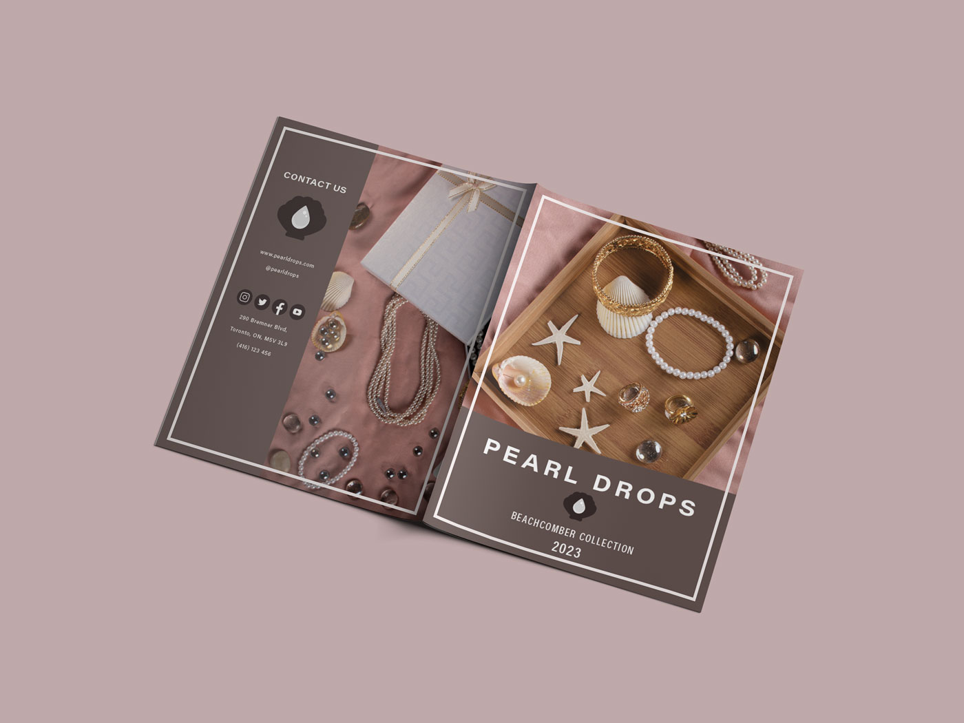 Front and back cover of a lookbook placed down showing pearl jewelry on a dark mauve background.
